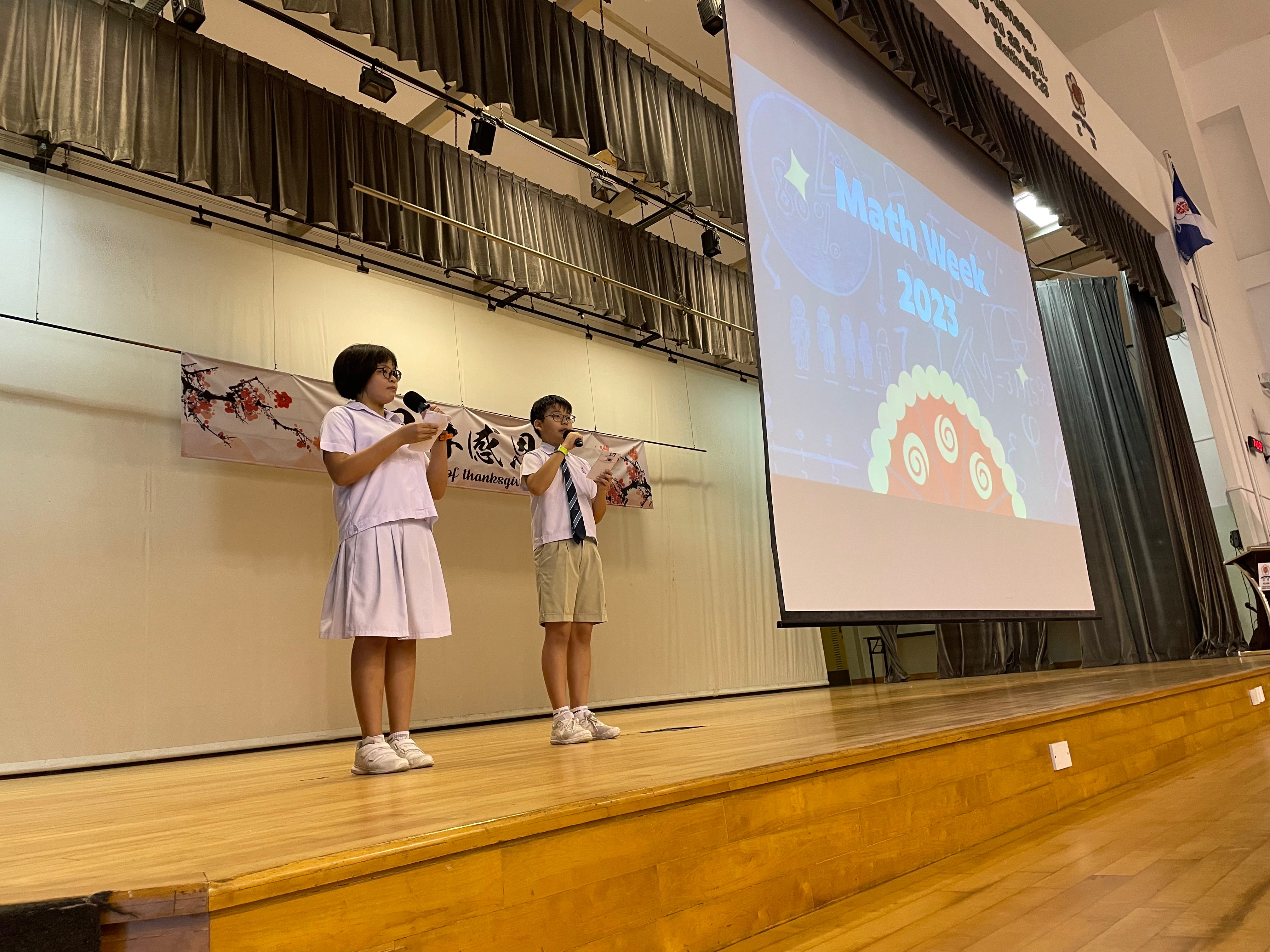 Math Leaders bringing their joy for math on stage - emceeing for Math Week Assembly programme
